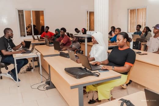 Instructor leading a hands-on coding class at Jasseh Code Camp
