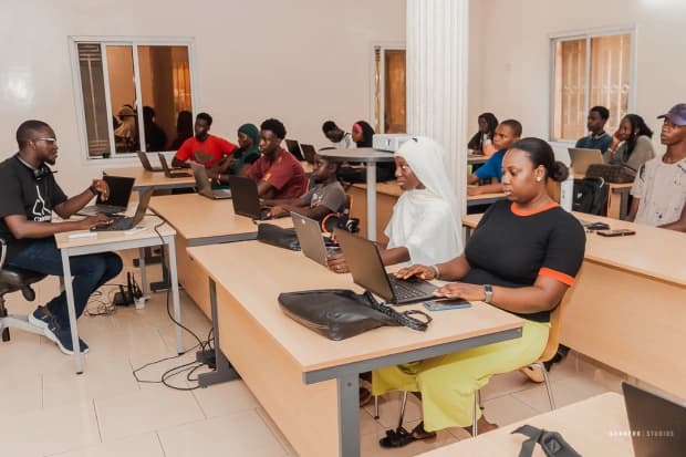 Instructor leading a hands-on coding class at Jasseh Code Camp
